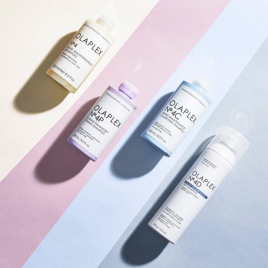 Four OLAPLEX shampoo products lined up in pastel colors