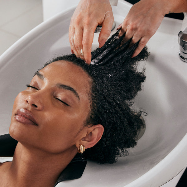 Woman receiving hair treatment at a salon