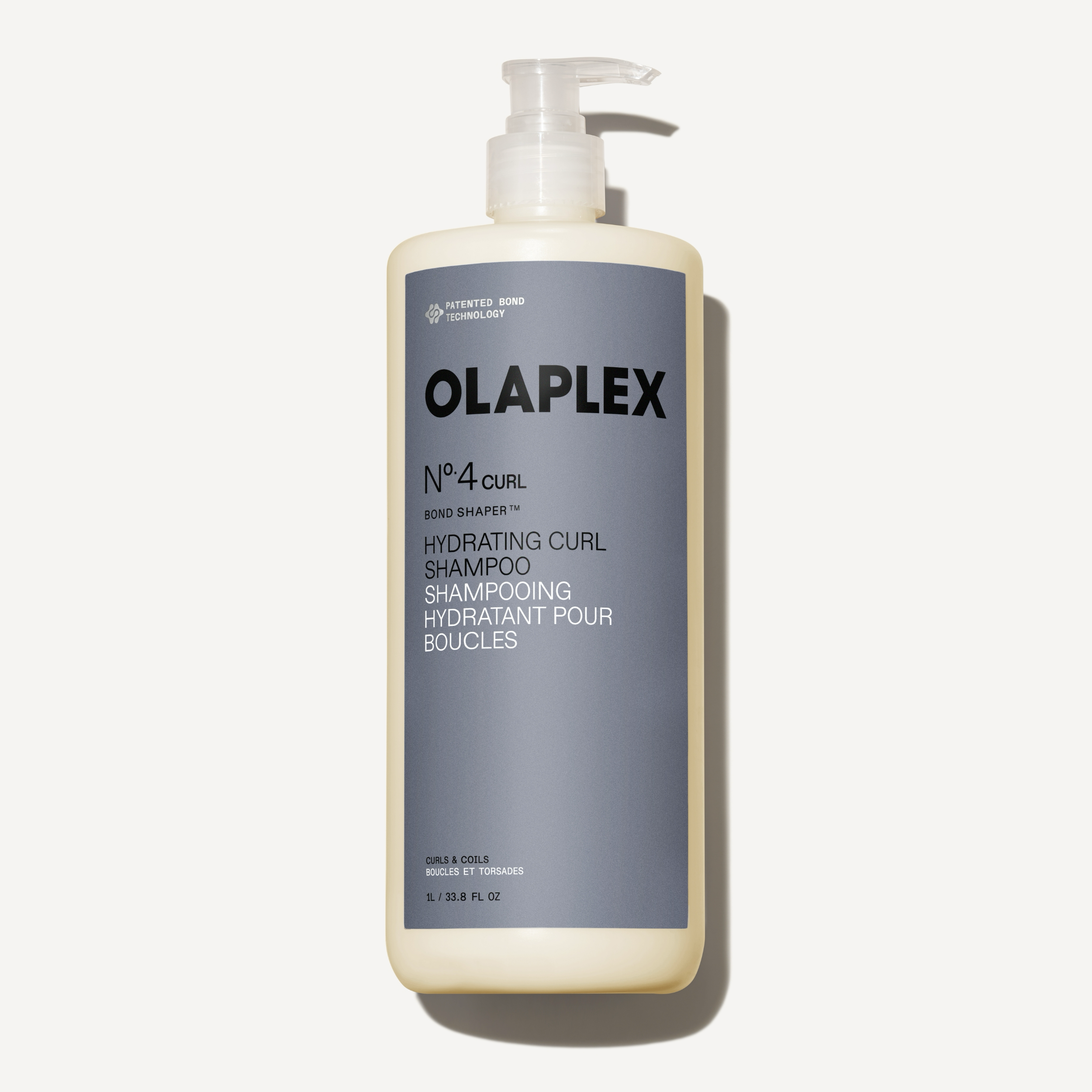 Flacone di Olaplex Nº.4CURL Bond Shaper Hydrating Curl Shampoo da 1000 ml su uno sfondo bianco neutro.