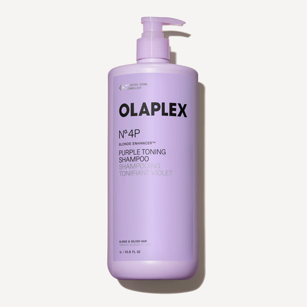 Un flacone da un litro di Olaplex No. 4P Blonde Enhancer Purple Toning Shampoo con dosatore a pompa, centrato su uno sfondo bianco pulito. - main view
