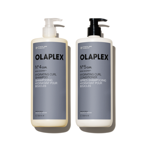 A liter-size set featuring OLAPLEX Nº.4CURL Bond Shaper Hydrating Curl Shampoo and Nº.5CURL Bond Shaper Hydrating Curl Conditioner. Both 1L / 33.8 fl oz bottles feature pump dispensers and are labeled for coils, curls, and waves. - main view